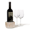 handmade beige rectangular bone arranged vertically on white wood wine bottle coaster with wine bottle inside and two glasses