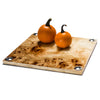 handmade light brown and dark brown spotted burn veneer square serving board with hammered german silver circles on corners and orange fruit on top