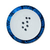handmade blue mother of pearl iridescent rim of charger plate with white plate and seven blueberries