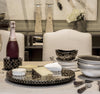 Tablescape with bamboo lazy susan bamboo wine bottle coaster bamboo accent bowl and wine bottle and cheeses