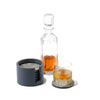 handmade gray almendro round wood bone coaster set with coasters in container with decanter and glass