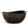 handmade light brown bamboo rings on black serving bowl with black wood interior and silver handles