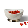 handmade almendro wood accent bowl with off-white pattern and base containing fresh cranberries