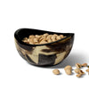 handmade horn veneer accent bowl with brown and beige geometric pattern containing pistachios