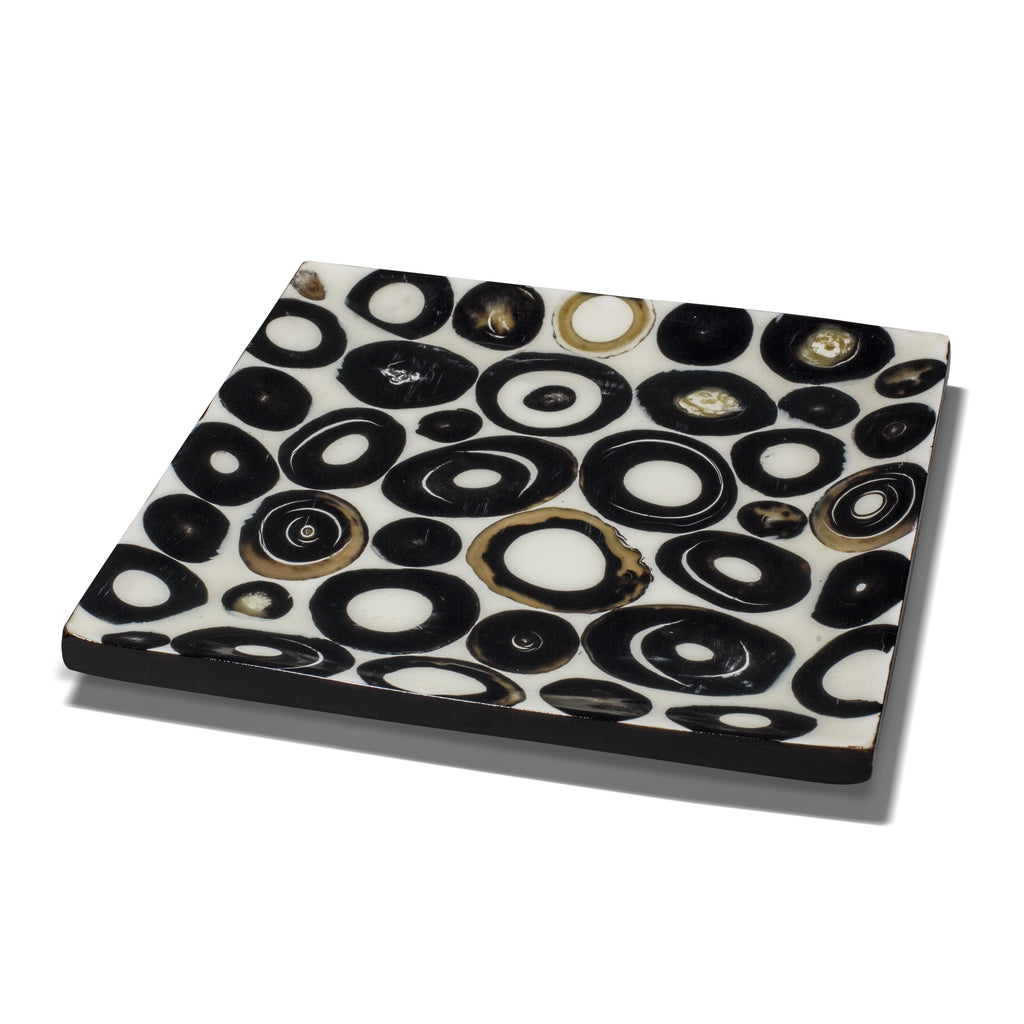 handmade horn veneer white small platter with several black and beige rings