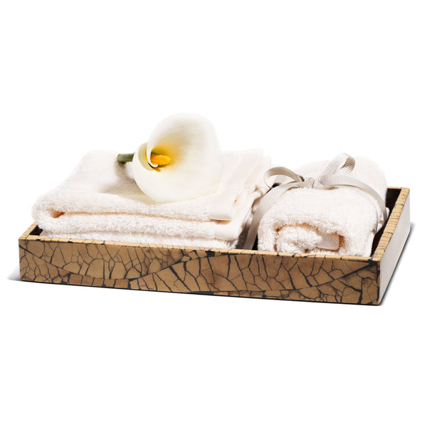 handmade beige and black mosaic patterned totumo wood bath tray with towels and flower inside