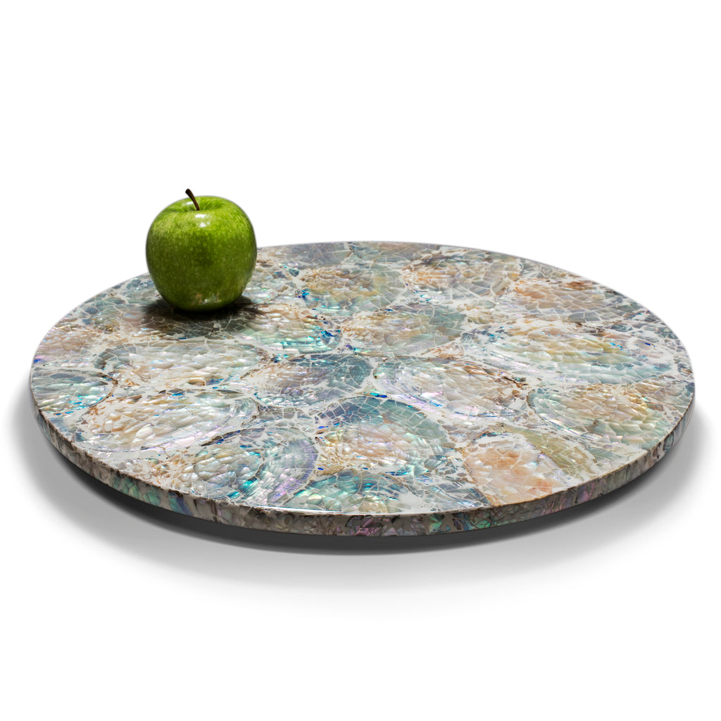 handmade iridescent colors with white natural mother of pearl round lazy susan revolving tray on wood with green apple on top