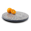 handmade gray round lazy susan with white bone inlay in floral pattern with oranges on top